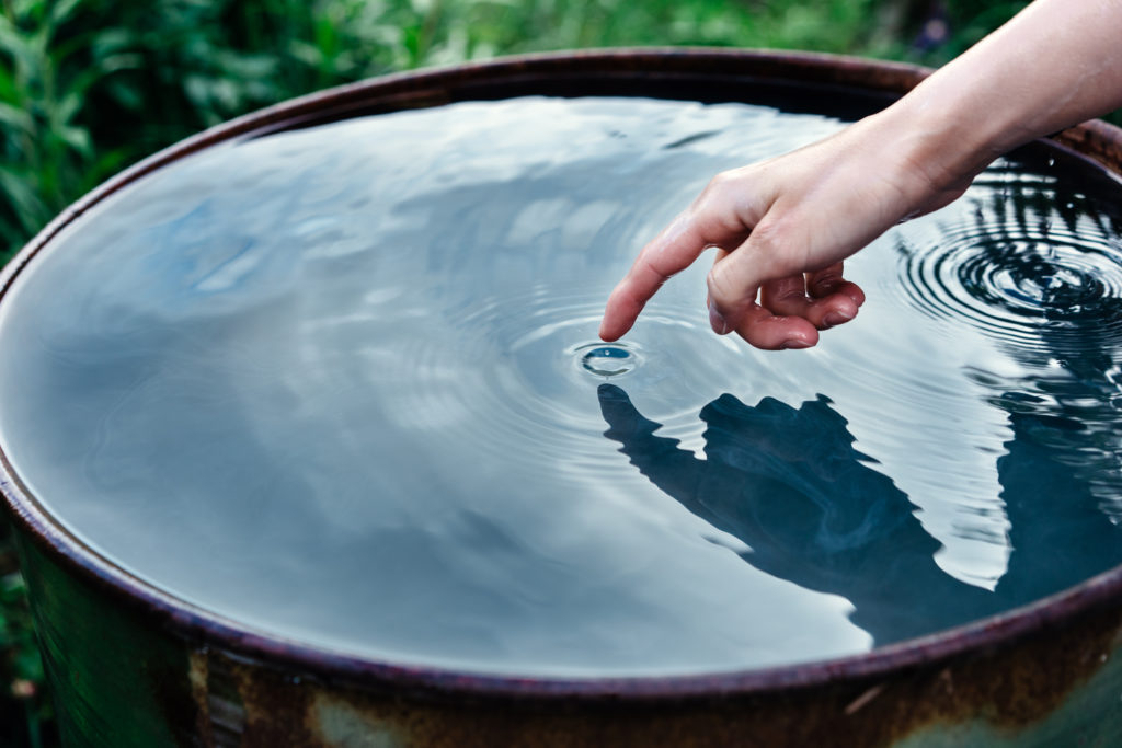 Closeup of a woman's hand touching water